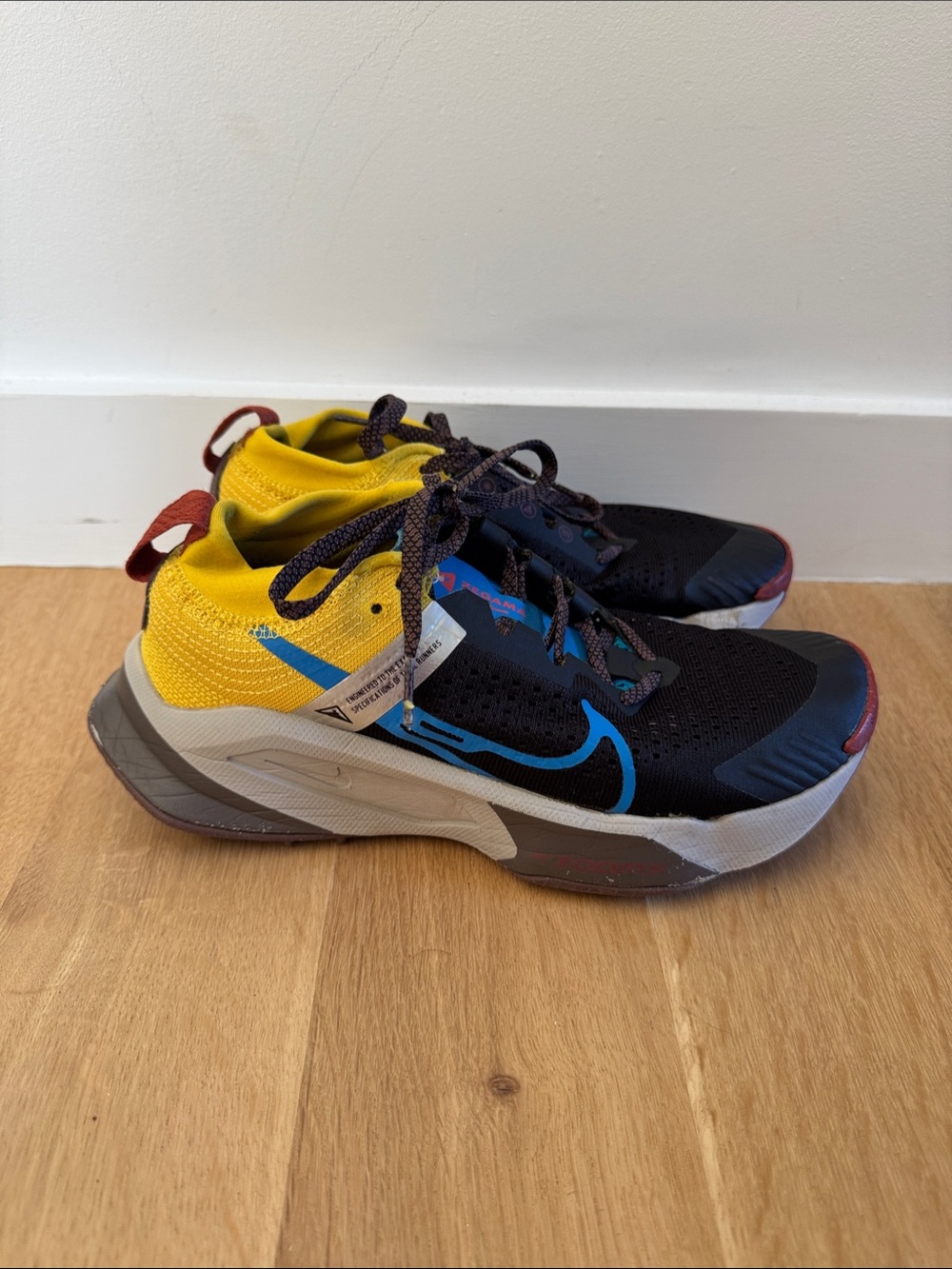 Nike women’s Zegama Black & Yellow Sneakers with Blue Swoosh